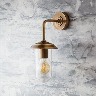 Curlew IP44 wall light in antique brass