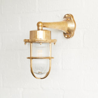 Magellan ip64 wall mounted sconce in unlacquered natural brass