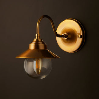 Goliath IP44 wall light in antiqued brass and glass with hat