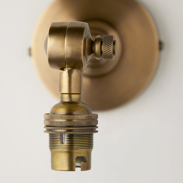 Elbow wall fitting in antiqued brass