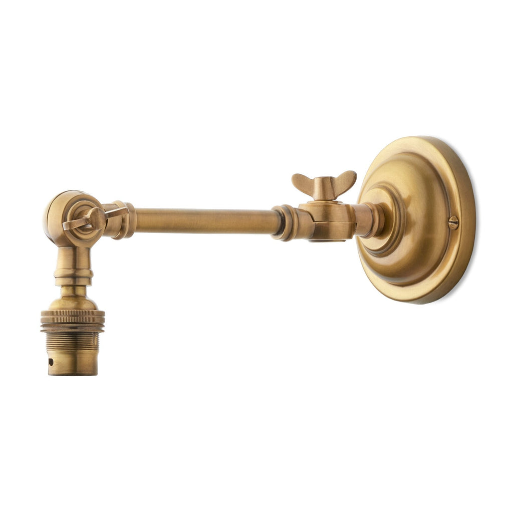 Double jointed wall fitting in antiqued brass