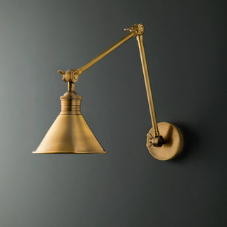 Stork wall light in antique brass